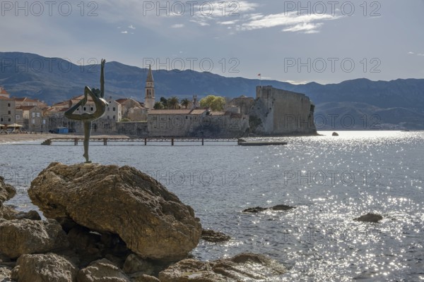 Statue of a ballerina against the background of the old town centre of Budva, Montenegro, Balkans