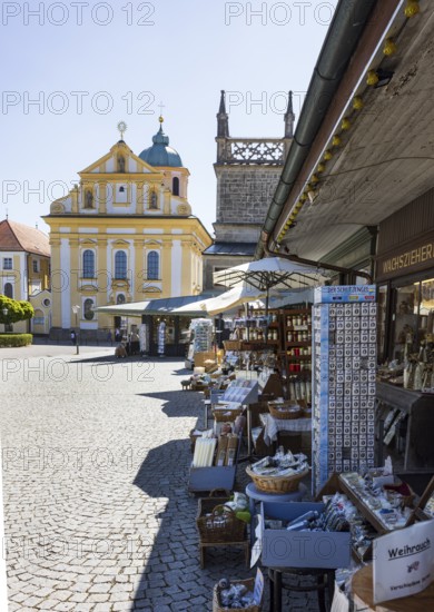 Souvenir shops at Kapellplatz with St Magdalena's Church, place of pilgrimage, Altötting, Upper Bavaria, Bavaria, Germany