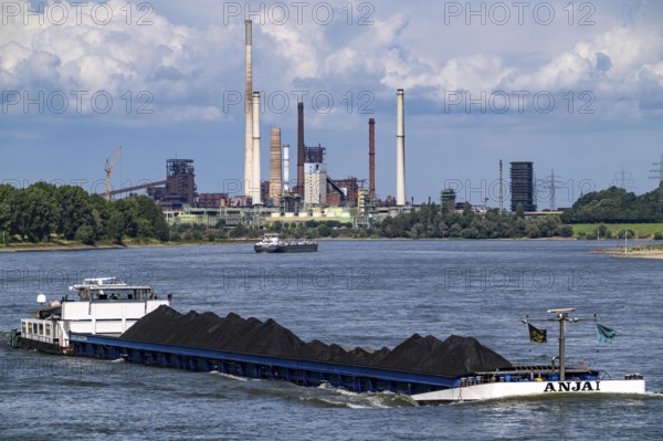 Industrial scenery of the ThyssenKrupp Steel steelworks in Duisburg-Bruckhausen, cargo ships on the Rhine, freighter Anja I, loaded with coal, blast furnaces, coking plant Schwelgern, Duisburg, North Rhine-Westphalia, Germany