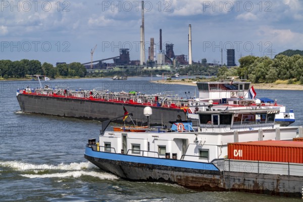 Industrial backdrop of the ThyssenKrupp Steel steelworks in Duisburg-Bruckhausen, cargo ships on the Rhine, blast furnaces, Schwelgern coking plant, Duisburg, North Rhine-Westphalia, Germany