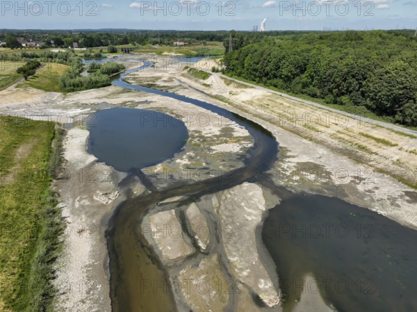 Dortmund, Castrop-Rauxel, North Rhine-Westphalia, Germany - River renaturalisation, renaturation of the Emscher, flood retention basin HRB Mengede. A new floodplain landscape is being created at the Emscher-Auen farm, expanding the area for flood protection during heavy rainfall and for biodiversity. The previously straightened Emscher is being given curves again and can meander through its new floodplain. Following the construction of a parallel sewer, the Emscher has been completely free of sewage since 2022. The river was previously an open, above-ground mixed water channel with rainwater and wastewater. At the back right, the Uniper coal-fired power plant Datteln 4 power station