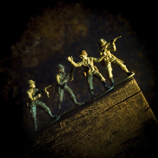 A group of toy soldiers are captured in motion as they navigate a steep incline, showcasing teamwork and strategy
