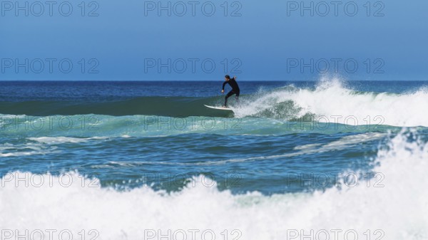 Surfer riding a wave on Contis beach, Saint Julien en Born, Saint-Julien-en-Born, Landes, France