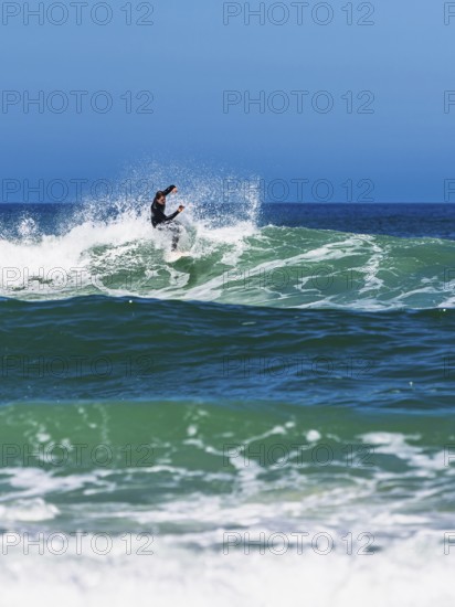 Surfer riding a wave on Contis beach, Saint Julien en Born, Saint-Julien-en-Born, Landes, France