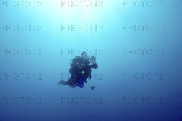 A diver floats alone during a safety stop in the blue depths of the Mediterranean Sea near Hyères, Giens Peninsula dive site, Provence Alpes Côte d'Azur, France