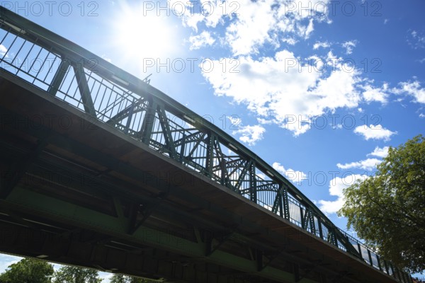 Steel bridge against the sunny sky in a dramatic perspective, Iron Bridge in Neunkirchen, Lower Austria, Austria