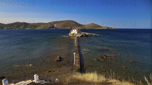 Distant view of the chapel on a rocky island, surrounded by mountains and sea, chapel, church, Agios Isidoros, rocky islet, bay of Gourna, Kokkali, Leros, Dodecanese, Greek Islands, Greece
