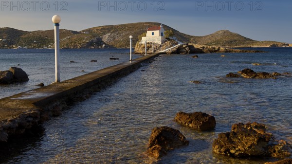 A narrow pier leads to a small church on a rock surrounded by the sea, chapel, church, Agios Isidoros, rocky islet, Bay of Gourna, Kokkali, Leros, Dodecanese, Greek Islands, Greece