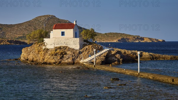 Chapel on rock in the warm morning light, surrounded by calm sea, Chapel, Church, Agios Isidoros, Rocky islet, Bay of Gourna, Kokkali, Leros, Dodecanese, Greek Islands, Greece