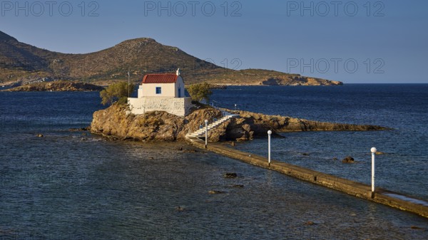 Quiet, peaceful coastal scene with chapel on rocky island, surrounded by blue water, chapel, church, Agios Isidoros, rocky islet, Bay of Gourna, Kokkali, Leros, Dodecanese, Greek Islands, Greece