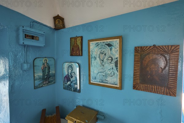 A room decorated with icons and blue-painted walls inside the church, chapel, church, Agios Isidoros, rocky islet, Gourna Bay, Kokkali, Leros, Dodecanese, Greek Islands, Greece