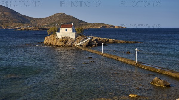 Calm scene with chapel on rocks in the sea under morning light, chapel, church, Agios Isidoros, rocky islet, Bay of Gourna, Kokkali, Leros, Dodecanese, Greek Islands, Greece