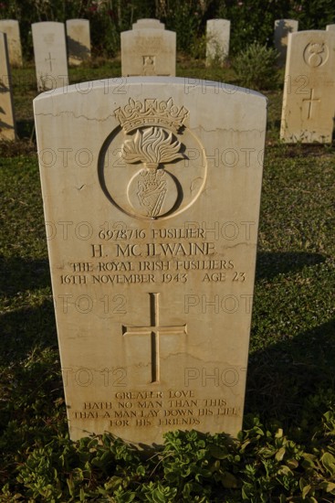 An inscribed gravestone with an emblem and carefully engraved text, surrounded by lawn, Military Cemetery, Commonwealth War Cemetery, Military Cemetery, WW2, 1939-1945, 179 graves, Alinda, Leros, Dodecanese, Greek Islands, Greece