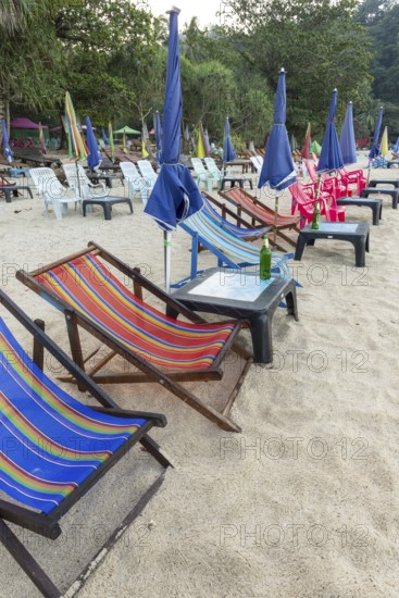 Abandoned deckchairs and parasol after sunset at Charlie Beach, Koh Mook Island, Andaman Sea, Thailand, Southeast Asia