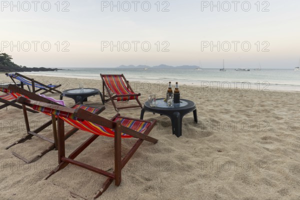 Abandoned deckchairs and parasol after sunset at Charlie Beach, Koh Mook Island, Andaman Sea, Thailand, Southeast Asia