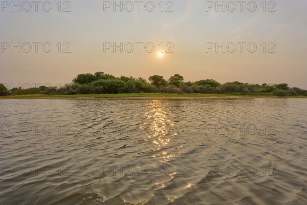 Sunrise over a river, calm reflections in the water, peaceful and natural atmosphere, Rio Negro, Fazenda Barranco Alto, Pantanal, UNESCO Biosphere Reserve, World Heritage Site, Mato Grosso, Brazil