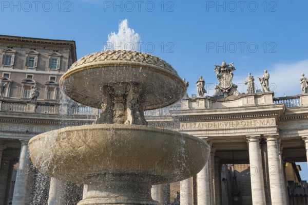 In the foreground fountain fountain by Bernini with a small water fountain, behind it part of a portico with Doric columns, above it the coat of arms of Pope Alexander VII and statues of saints, on the left in the background part of the building of the Apostolic Palace Palazzo Apostolico, Vatican City, Vatican, Rome, Lazio, Italy