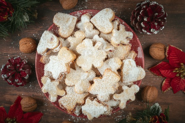 Plate full of cookies with Christmas decorations and walnuts