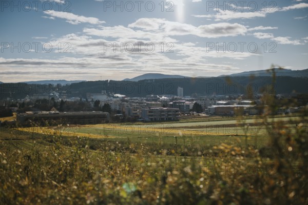 Urban landscape in a valley with vast fields and mountains in bright skies, Ternitz, Lower Austria, Austria