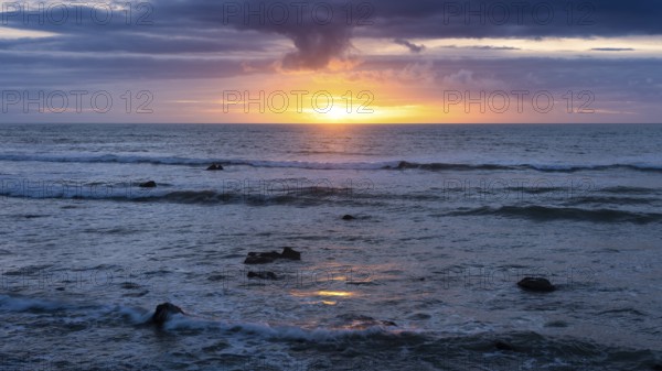 Sea in the evening at sunset, west coast of the Taranaki region, North Island, New Zealand