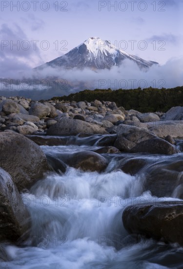Mount Taranaki in the evening after sunset, in the foreground Stony River (Hangatahua River) . Egmont National Park, Taranaki Region, North Island, New Zealand