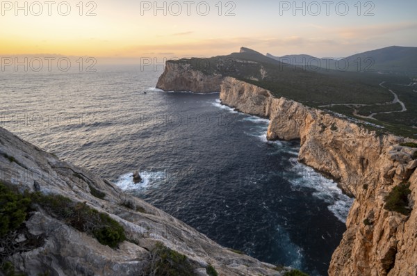 Coastal landscape at sunset, steep cliffs by the sea, cliffs in the evening light, Capo Caccia, Alghero, Sardinia