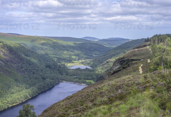 Upper Lake behind Lower Lake and round tower, Wicklow Mountains National Park, Glendalough, Brockagh, County Wicklow, Ireland