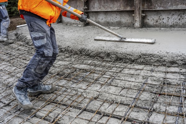 Concreting, concreting the foundation of a wind turbine, more than 600 cubic meters of concrete will be pumped into the foundation for over 7 hours, over 100 tons of reinforcing steel have been used, the wind turbine will have a hub height of 160 meters, part of a new wind farm in Sauerland, near Balve, North Rhine-Westphalia, Germany