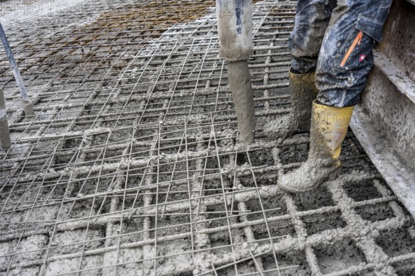Concreting, concreting the foundation of a wind turbine, concrete pump hose, more than 600 cubic meters of concrete will be pumped into the foundation for over 7 hours, over 100 tons of reinforcing steel have been used, the wind turbine will have a hub height of 160 meters, part of a new wind farm in Sauerland, near Balve, North Rhine-Westphalia, Germany