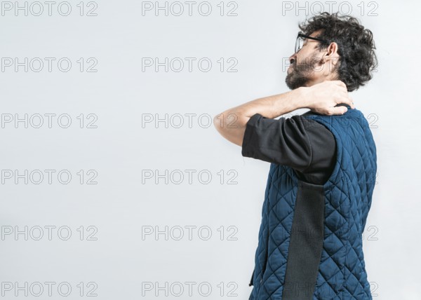 Suffering young man with stress and neck pain. Fatigued man with neck pain isolated