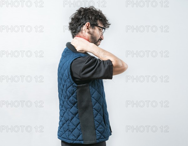 Fatigued man with neck pain isolated. Suffering young man with stress and neck pain