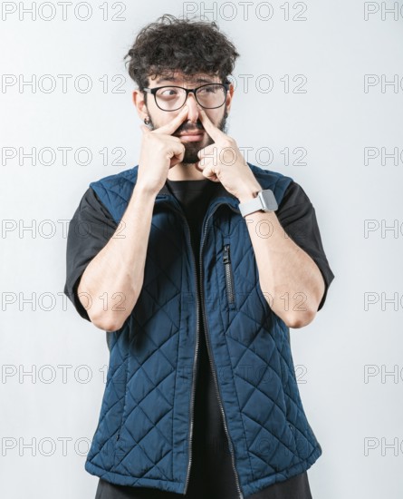 Young man with face of unpleasant odors, covering nose. Person covering nose because bad smells. Bad smells, Concept