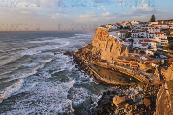 Scenic view of the seaside Azenhas do Mar fishing village on cliff on Atlantic ocean coast, Portugal on sunset