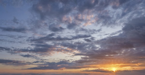 At sunset vibrant colors fill the sky, creating a stunning backdrop with dramatic clouds, perfect for relaxation and reflection