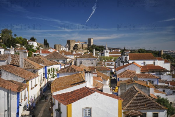 Stunning aerial view of Obidos, a medieval town in Portugal, showcasing its castle, city walls, and charming rooftops. Portugal