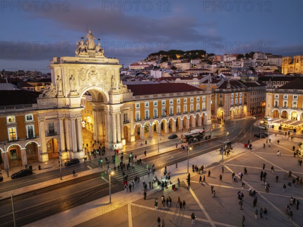Experience the magic of Christmas in Lisbon as Praca do Comercio glows with festive lights in the evening twilight