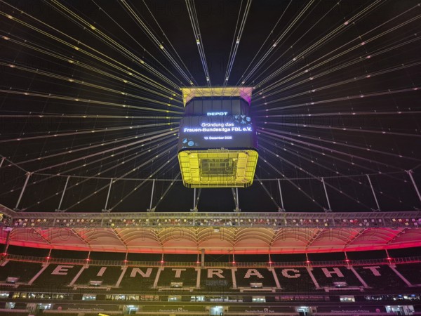 The Frankfurt Waldstadion (Deutsche Bank Park) is illuminated in red to mark the founding of the Women's Bundesliga Association and the video cube reads: Founding of the Women's Bundesliga FBL e.V. - 10 December 2025, Waldstadion, Frankfurt am Main, Hesse, Germany