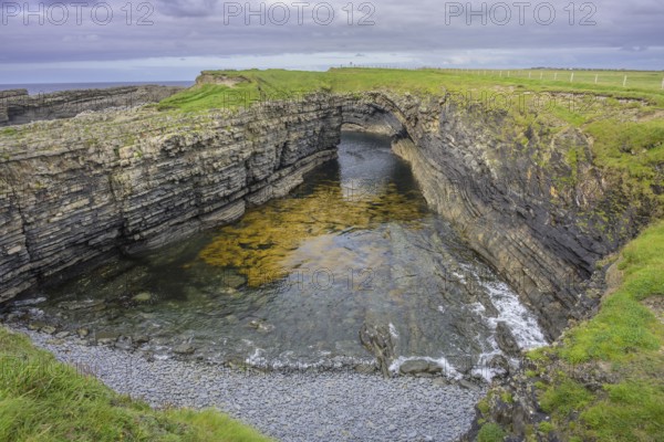 Bridges of Ross rock arch, Kilballyowen, County Clare, Ireland