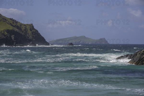 Waves crashing against cliffs in the background Inishtooskert Island (sleeping Giant), Clogher Strand, Dunurlin, Kerry, Ireland
