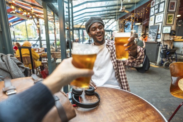 Friends enjoying a celebratory moment, raising refreshing beer glasses for a toast at a vibrant indoor outdoor pub setting, feeling happiness and togetherness