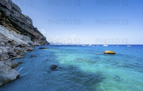 Light blue clear sea on a dream beach on Cala GoloritzÃ©, picturesque rocky coast, cliffs, Golfo di Orosei, Baunei, Sardinia, Italy