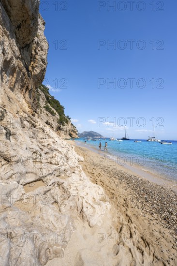 Sandy beach beach and steep cliffs at Cala Luna, Golfo di Orosei, Baunei, Sardinia, Italy