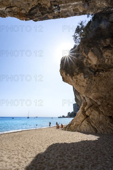 Sandy beach beach and steep cliffs at Cala Luna, Sun Star, Golfo di Orosei, Baunei, Sardinia, Italy