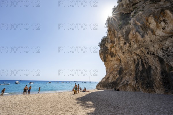 Sandy beach beach and steep cliffs with caves at Cala Luna, Sun Star, Golfo di Orosei, Baunei, Sardinia, Italy