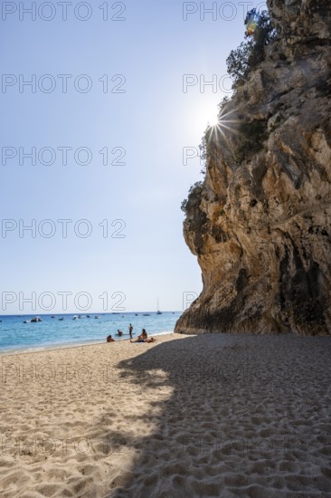 Sandy beach beach and steep cliffs with caves at Cala Luna, Sun Star, Golfo di Orosei, Baunei, Sardinia, Italy