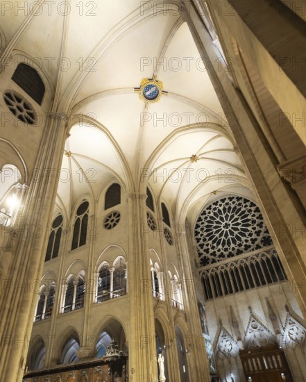 Notre dame de paris cathedral interior showcasing soaring gothic architecture. Pointed arches. Ribbed vaults. And intricate rose windows. Highlighting religious beauty and historical design in france