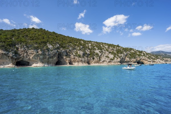 Clear blue water and picturesque rocky coast, Cala Luna cliffs and beach, Golfo di Orosei, Baunei, Sardinia, Italy