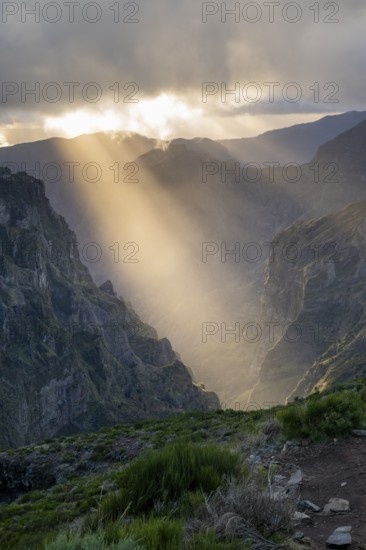 Sunset at Pico do Arieiro, sun shining through clouds, sunbeam, hiking trail PR1, Madeira, Portugal