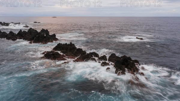 Sunset, waves and rocks, coast near Porto Moniz, Madeira, Portugal