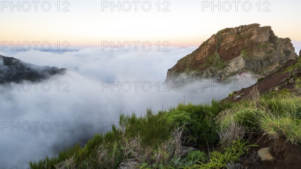 Sunrise at Pico do Arieiro, clouds of fog sweep over mountain peaks, sea of fog, hiking trail PR1, Madeira, Portugal